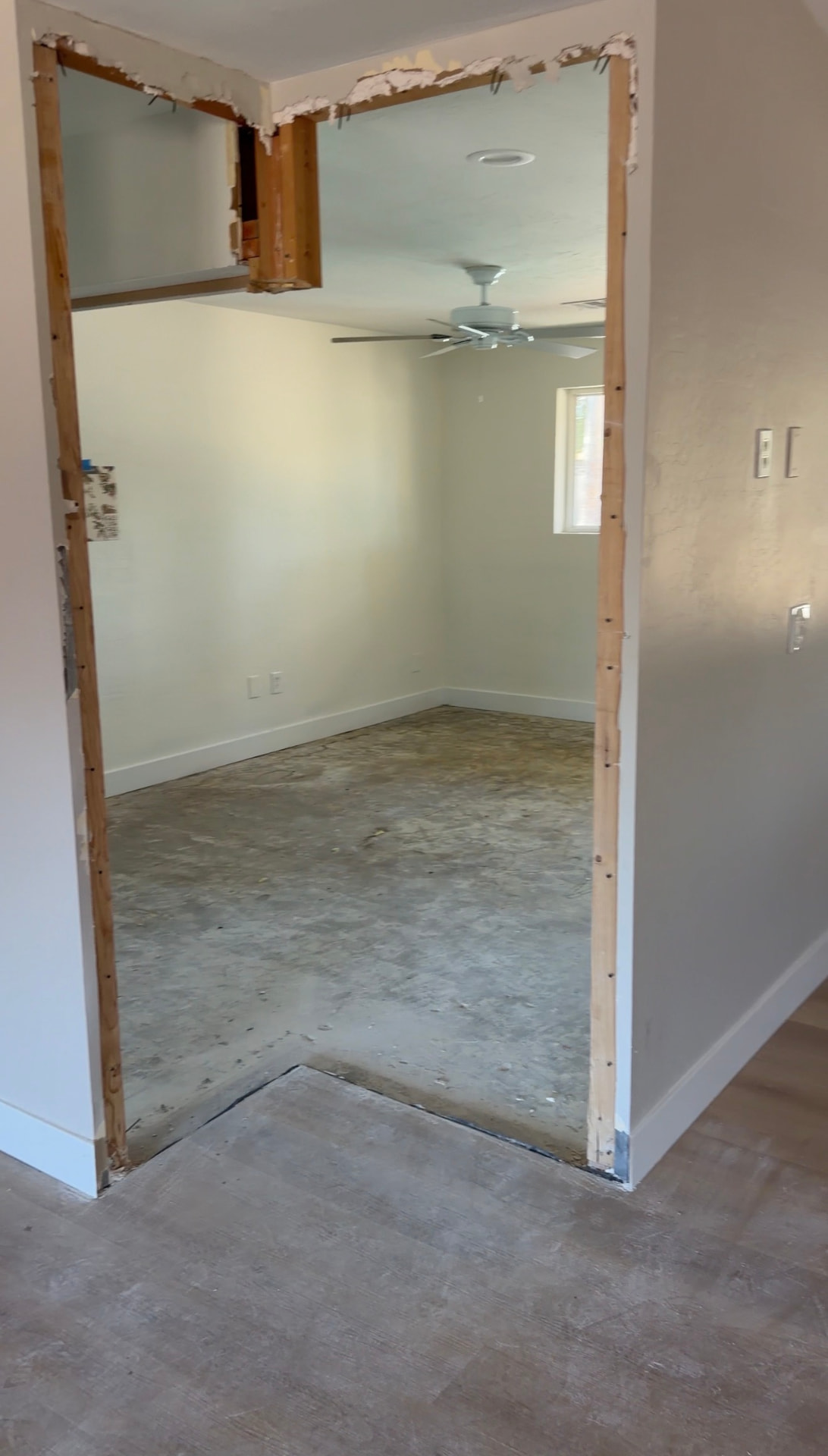 Interior demolition with drywall and framing removed from a doorway opening