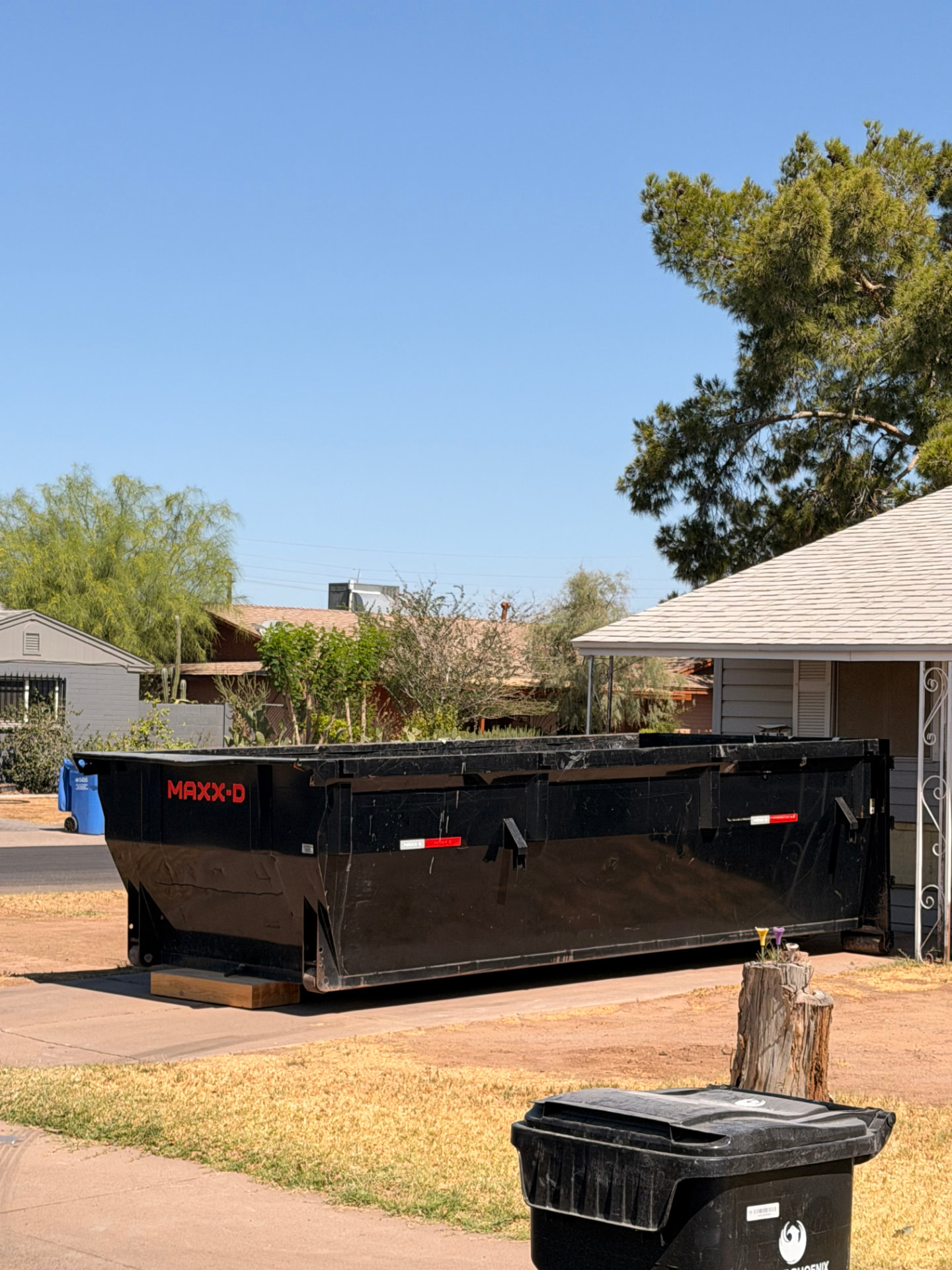 15-yard roll-off dumpster placed on a residential driveway in the Phoenix area